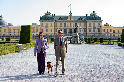 The King and Queen in Drottningholm Palace Park with their dog, Brandie